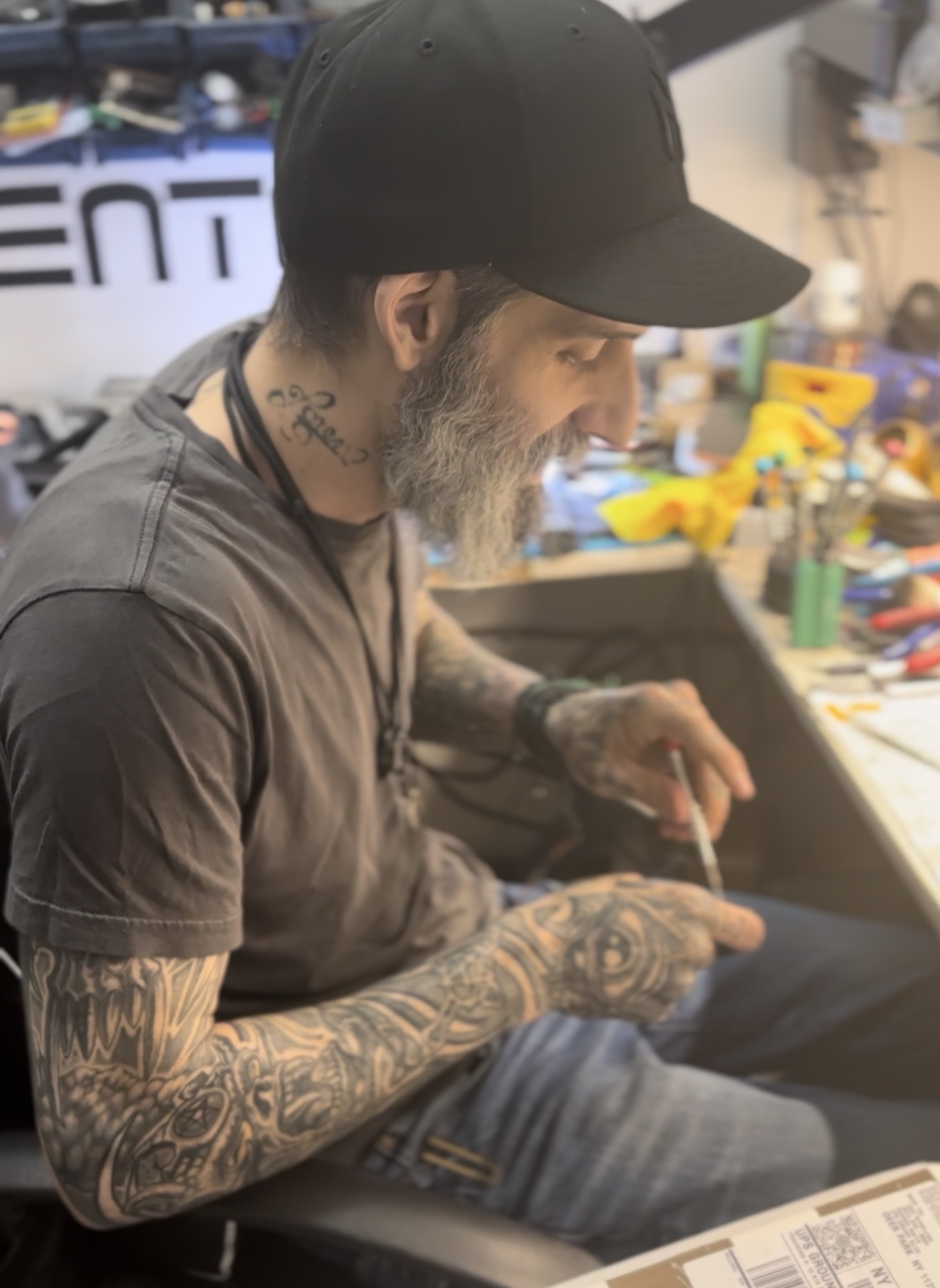 Jimi Calise, founder of JWS Electronics Repair, working at the repair bench