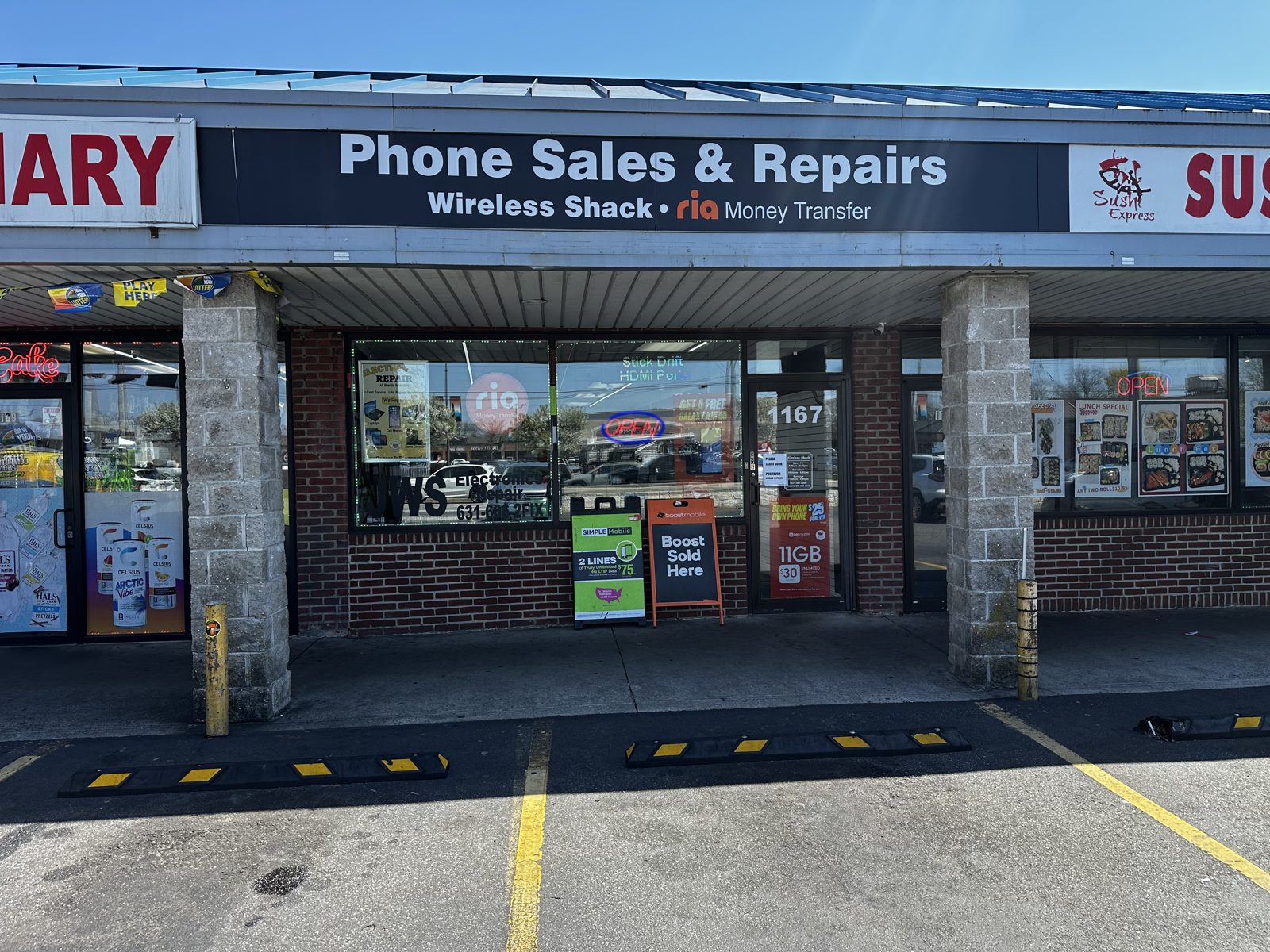 JWS Electronics Repair storefront inside Wireless Shack with the black-and-white Phone Sales & Repairs sign and address 1167